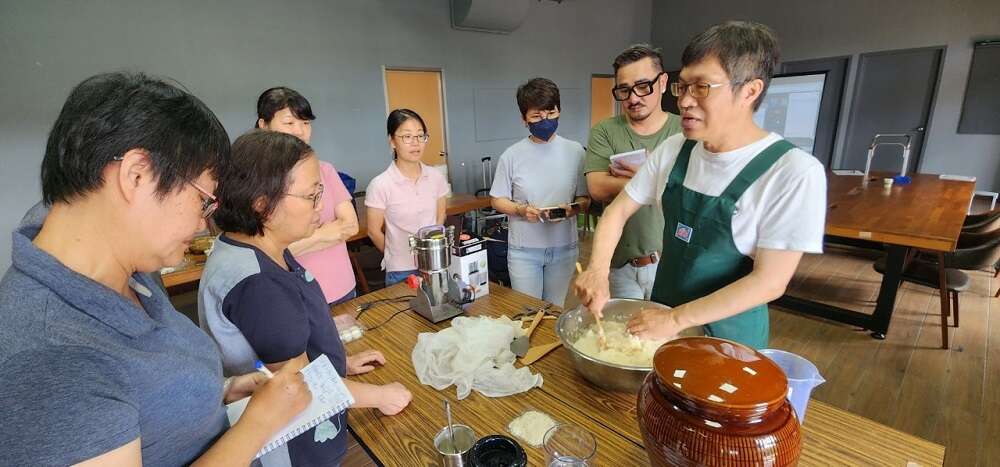 擅長阿美族製麴和釀造工法的丮硠‧瑪那(著圍裙者)。（丮硠‧瑪那提供）